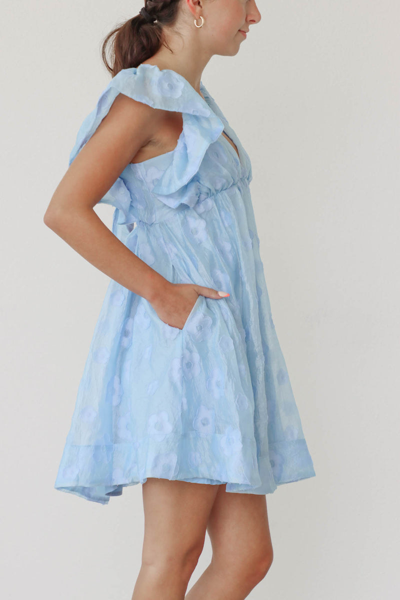 girl wearing light blue floral dress