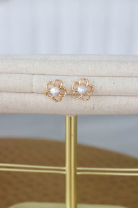 gold flower earrings with pearl in the center