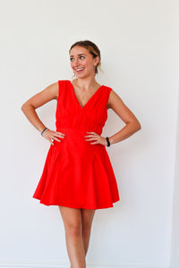 Woman wearing a red dress against a white background