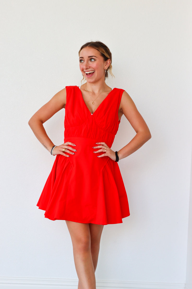 Woman wearing a red dress against a white background