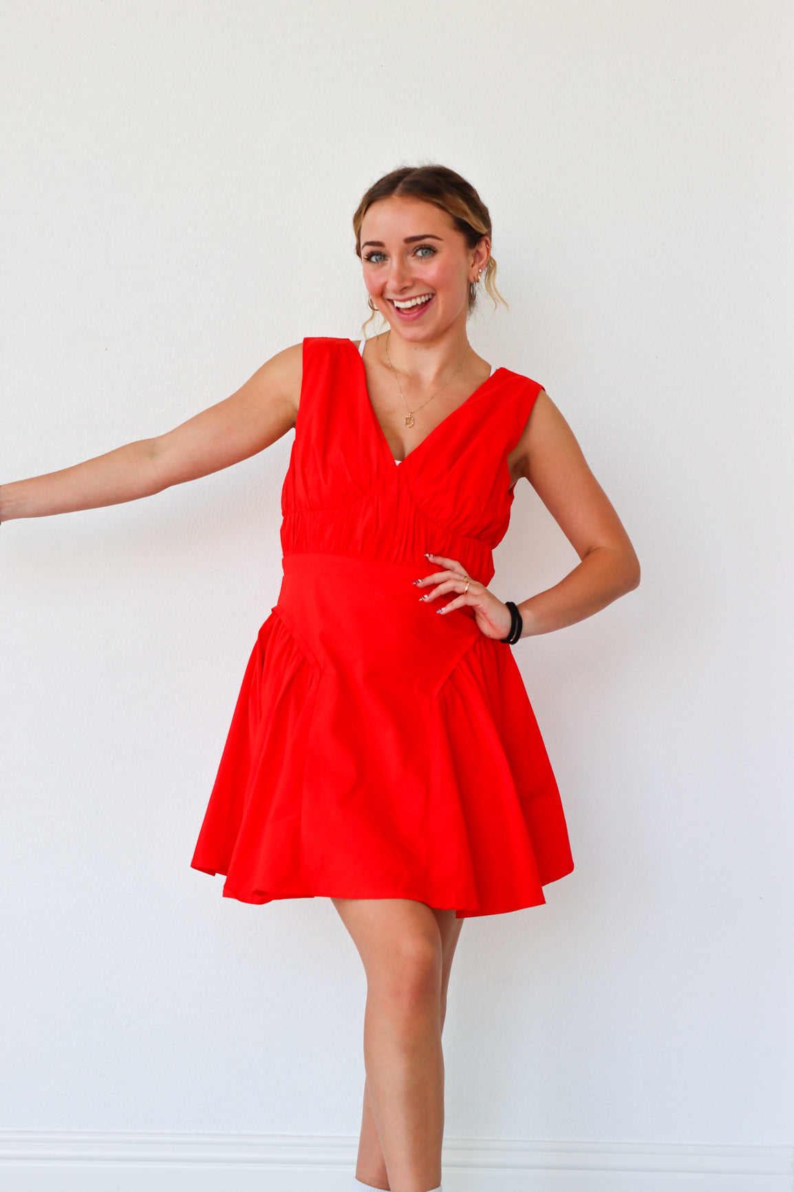 Woman wearing a red dress against a white background