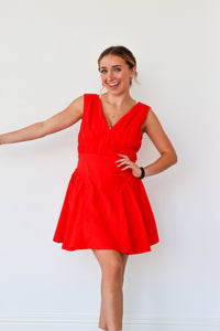 Woman wearing a red dress against a white background