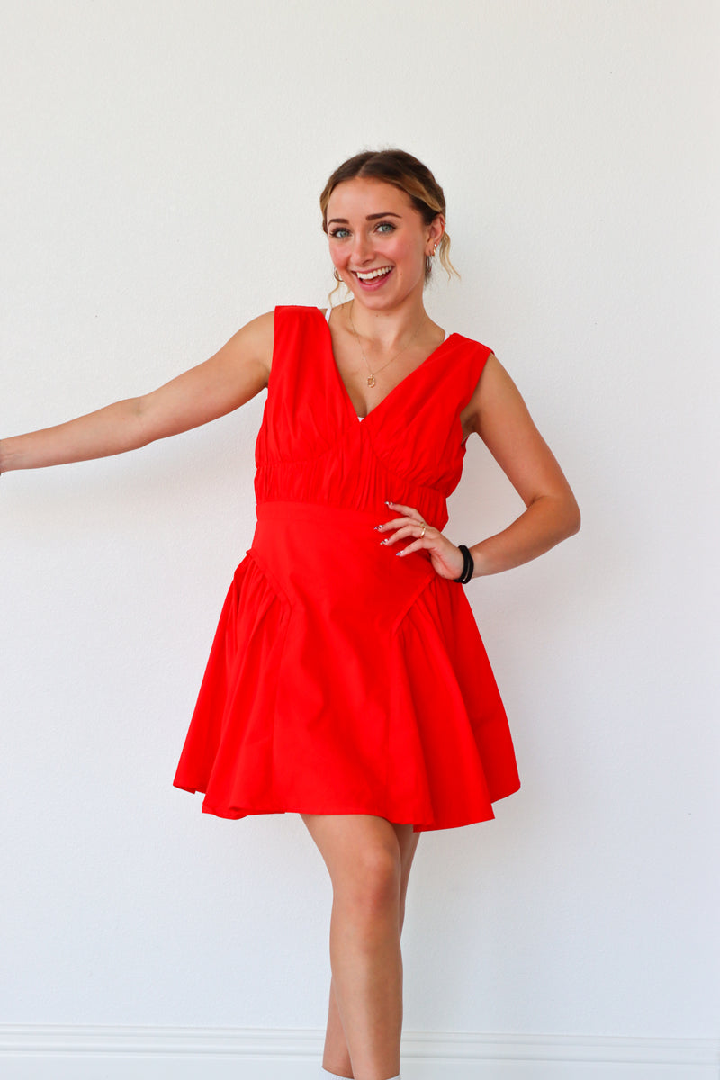 Woman wearing a red dress against a white background