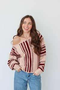 Woman wearing a dark red striped off the shoulder top 