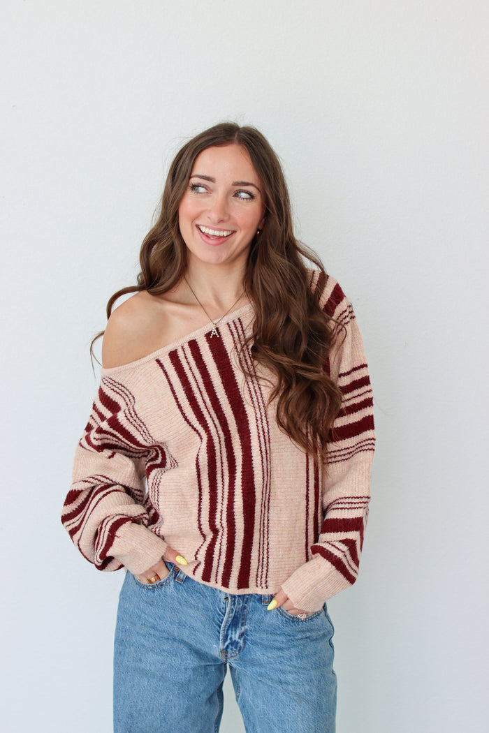 Woman wearing a dark red striped off the shoulder top 