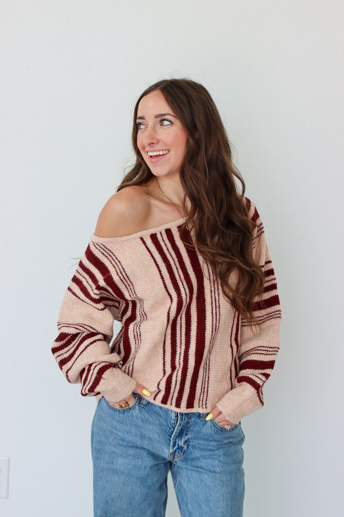 Woman wearing a dark red striped off the shoulder top 