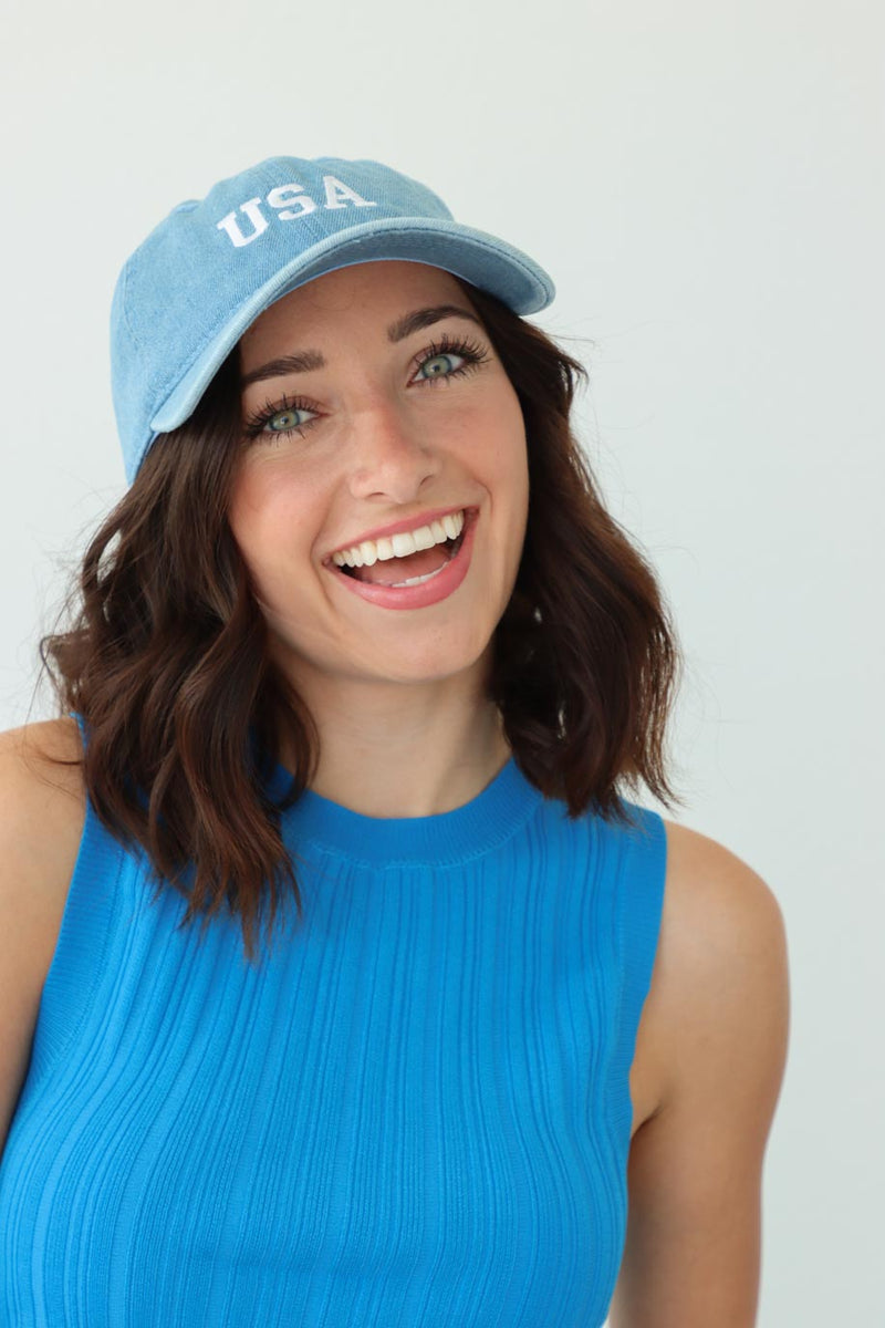 girl wearing light blue chambray hat with "usa" embroidery