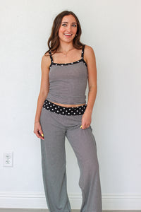 Woman wearing a black and white striped polka dot outfit set 