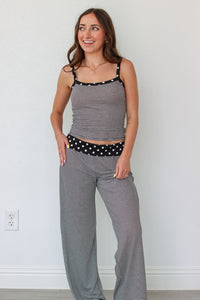 Woman wearing a black and white striped polka dot outfit set 