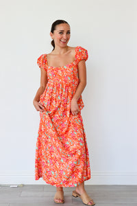 Woman wearing a floral dress against a white background