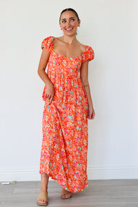 Woman wearing a floral dress against a white background