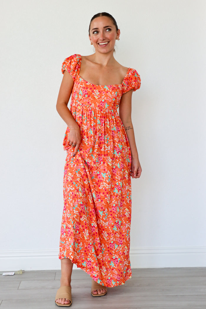 Woman wearing a floral dress against a white background