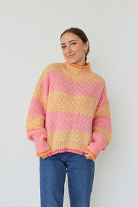 girl wearing pink and orange striped sweater