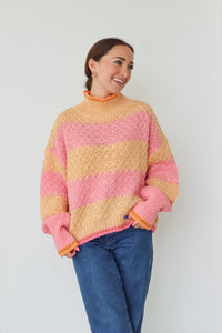 girl wearing pink and orange striped sweater