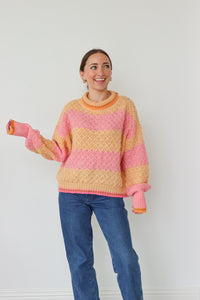 girl wearing pink and orange striped sweater