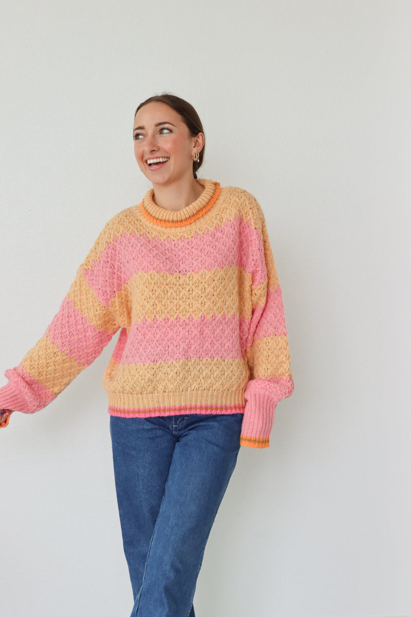 girl wearing pink and orange striped sweater