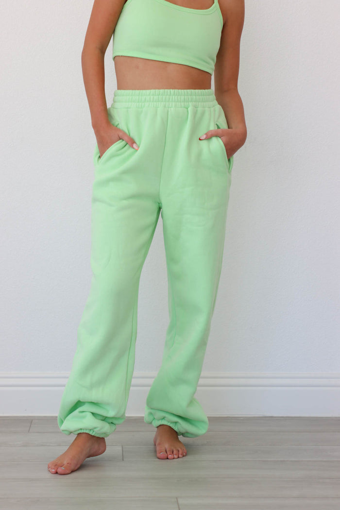 girl wearing lime green matching lounge set: sports bra and sweatpants