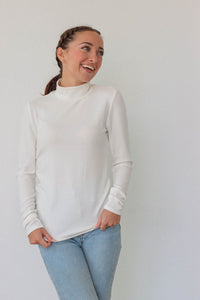 girl wearing white long sleeved turtleneck top