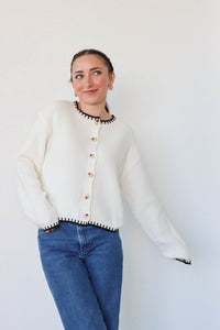 girl wearing white knit cardigan