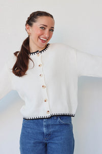 girl wearing white knit cardigan