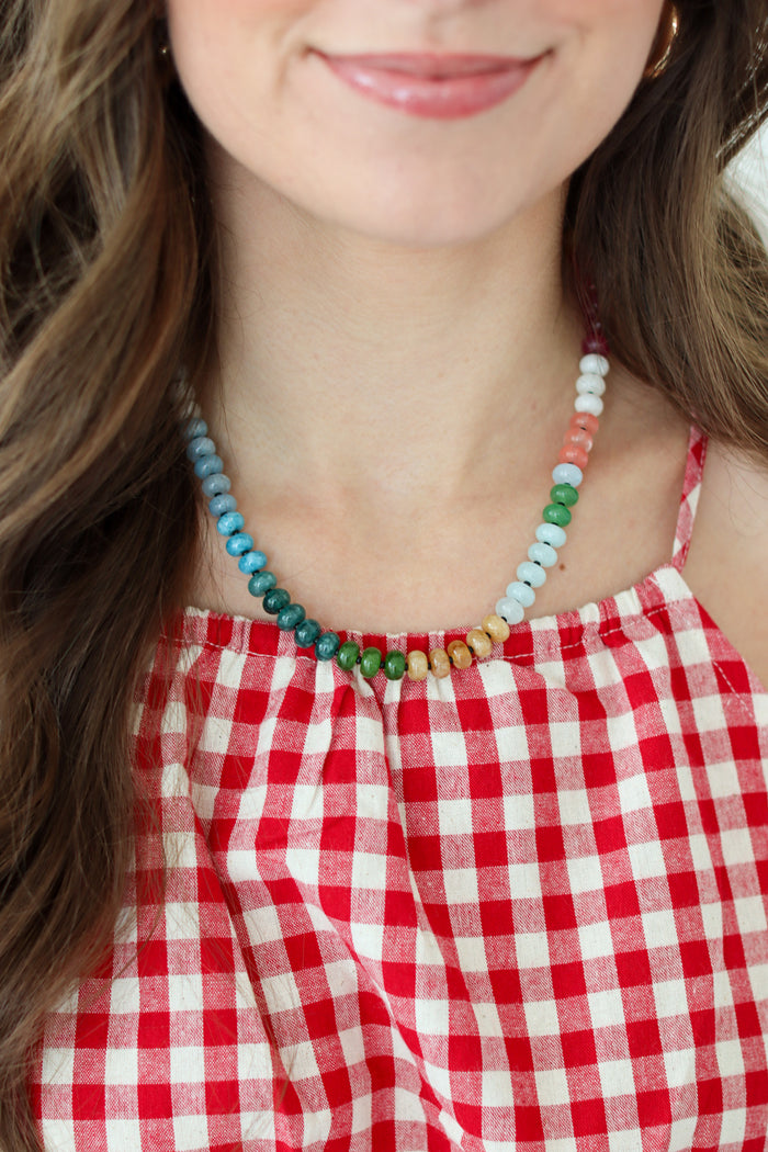 Woman wearing a rainbow beaded necklace 