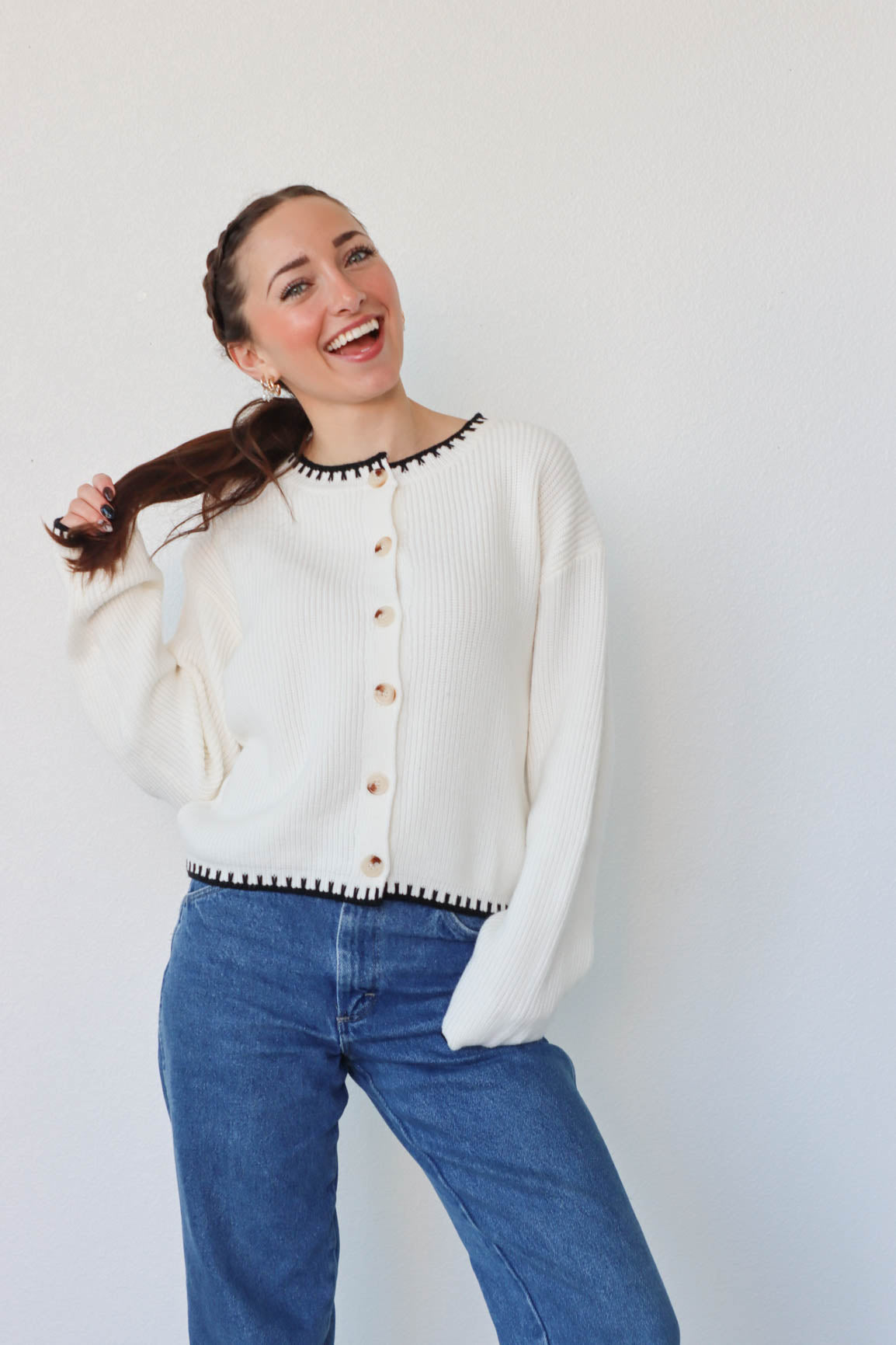 girl wearing white knit cardigan