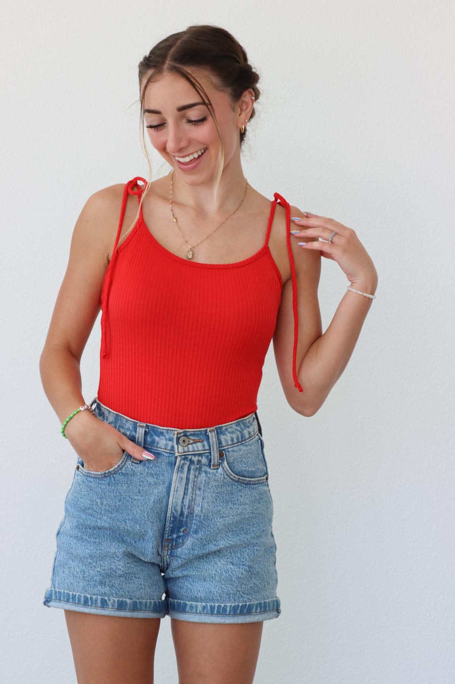 girl wearing red tank top bodysuit with tie straps