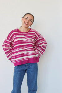 girl wearing purple and white striped knit sweater