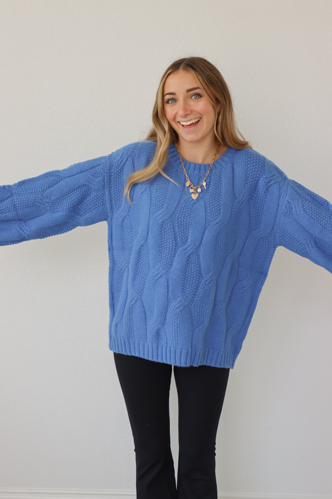 girl wearing royal blue cable knit sweater