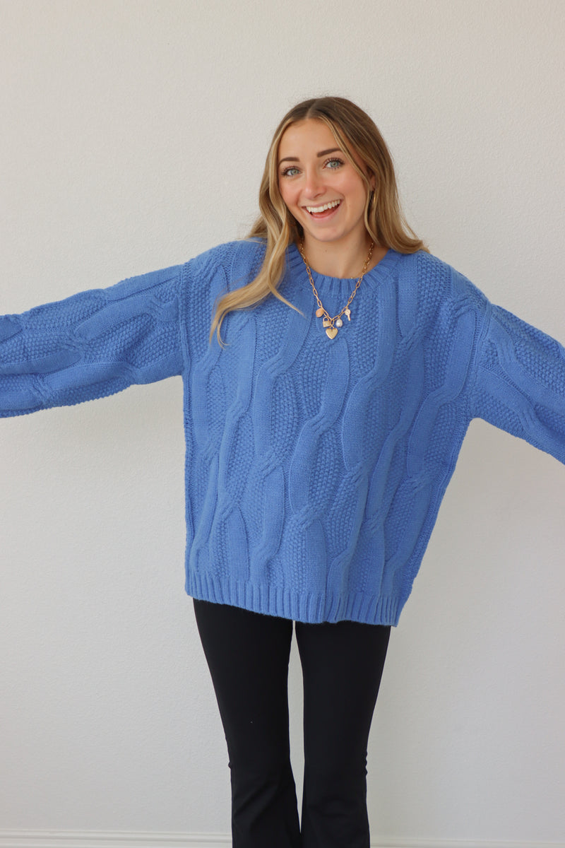 girl wearing royal blue cable knit sweater