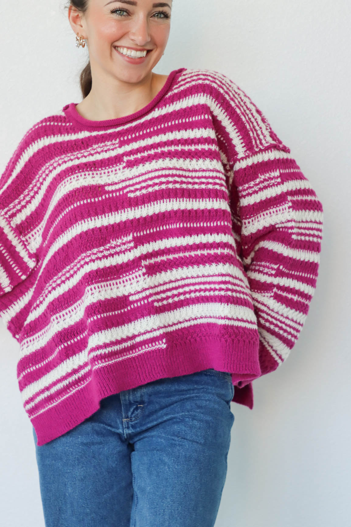 girl wearing purple and white striped knit sweater