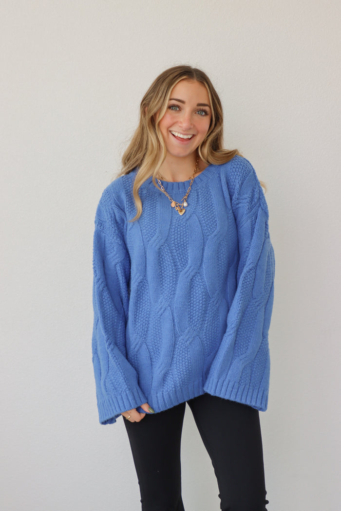 girl wearing royal blue cable knit sweater