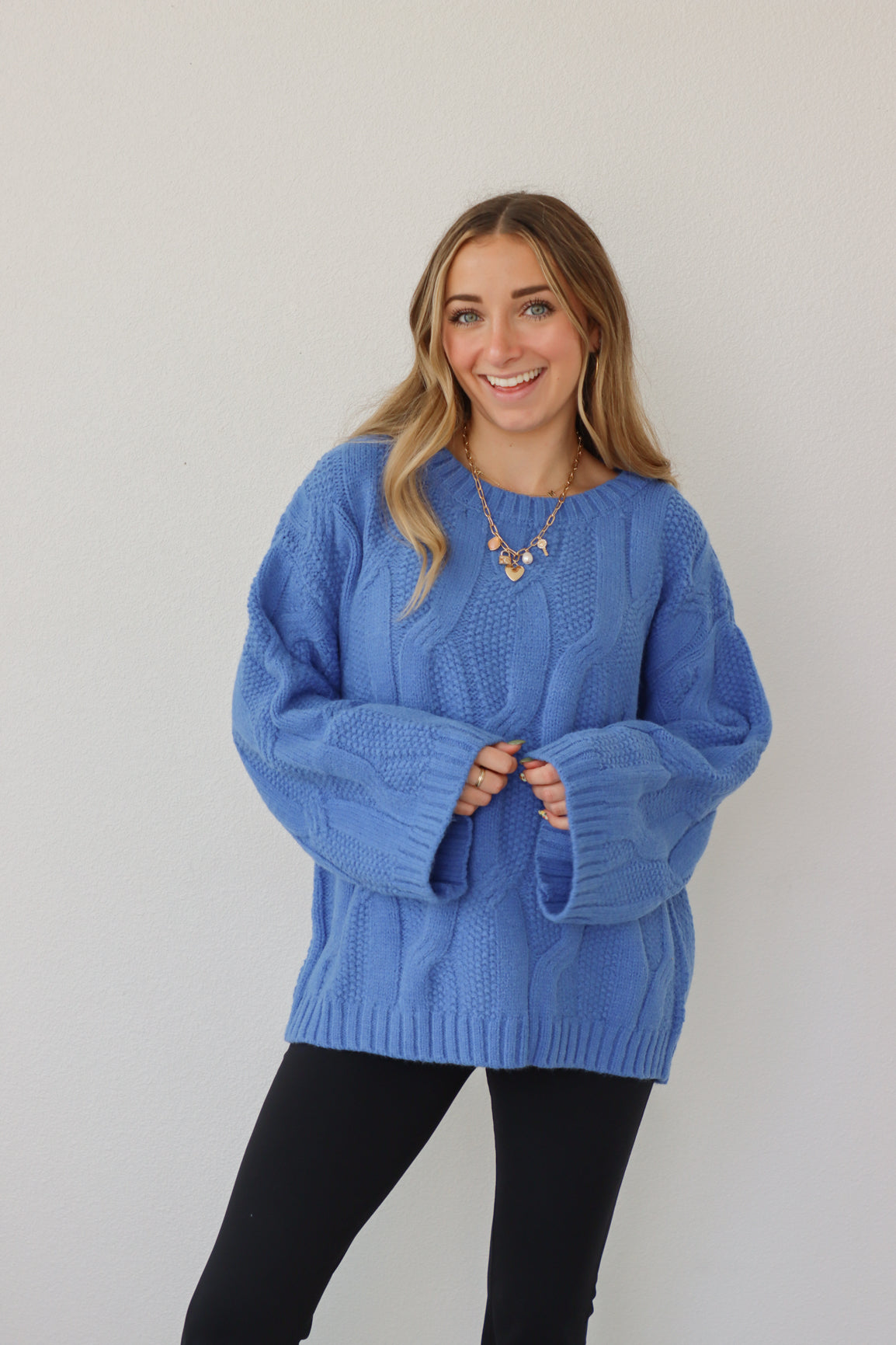 girl wearing royal blue cable knit sweater