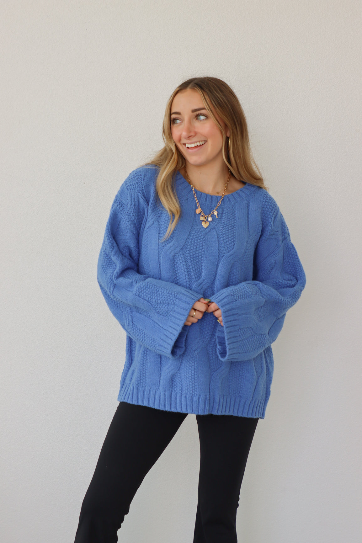 girl wearing royal blue cable knit sweater