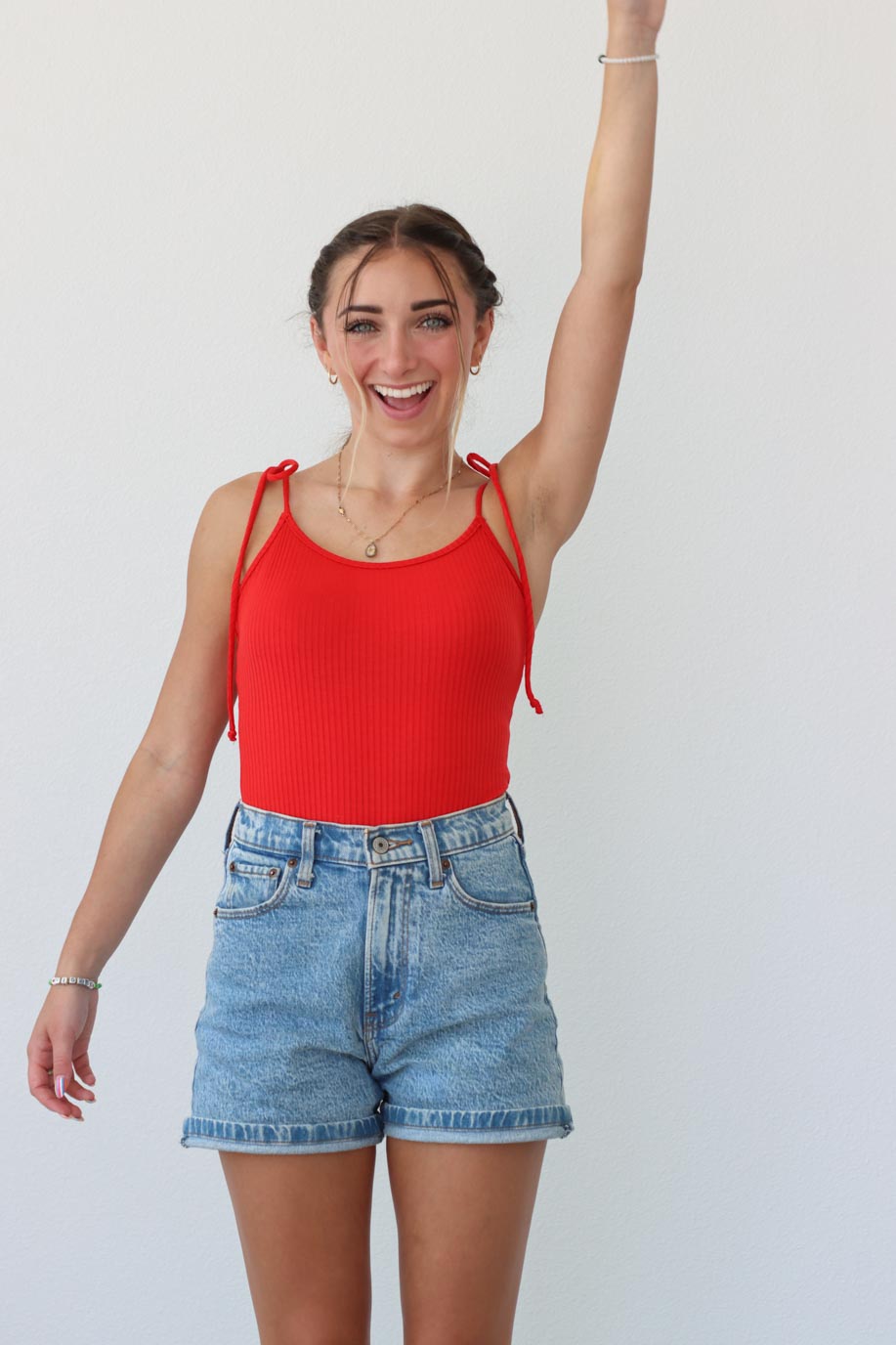 girl wearing red tank top bodysuit with tie straps