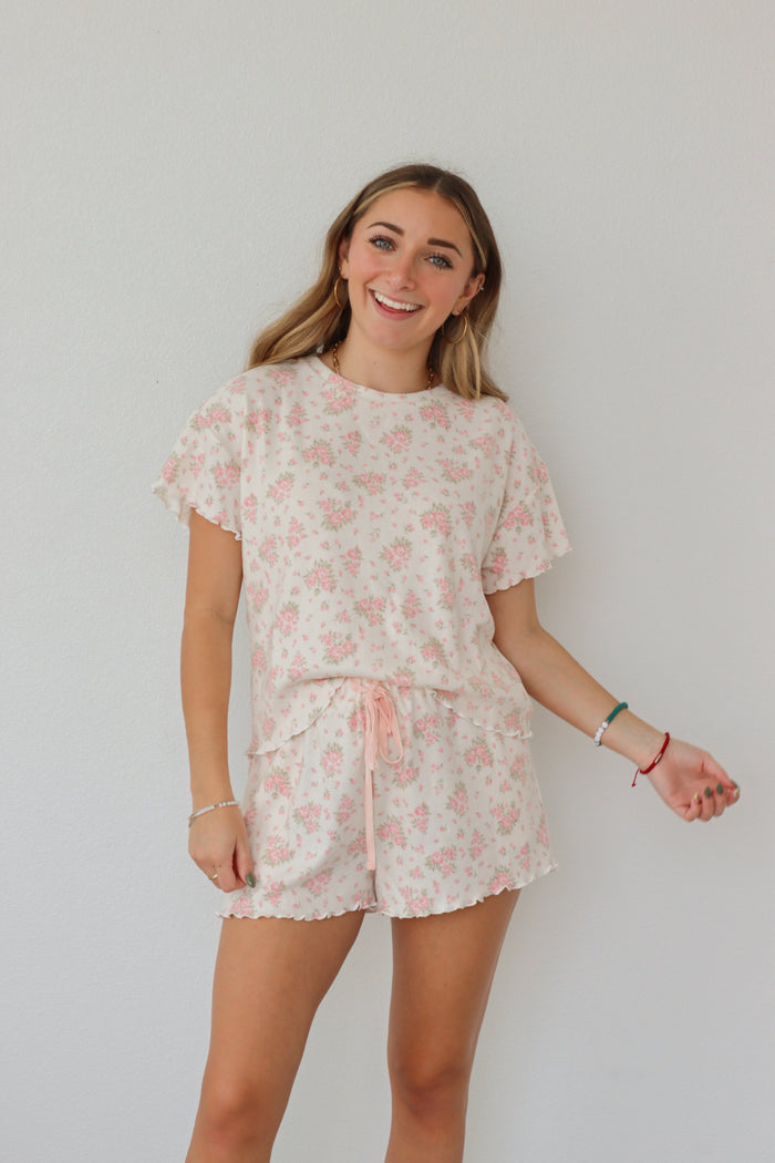 girl wearing light pink floral pj set