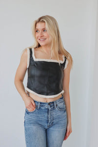 girl wearing faux leather tank top with sherpa detailing