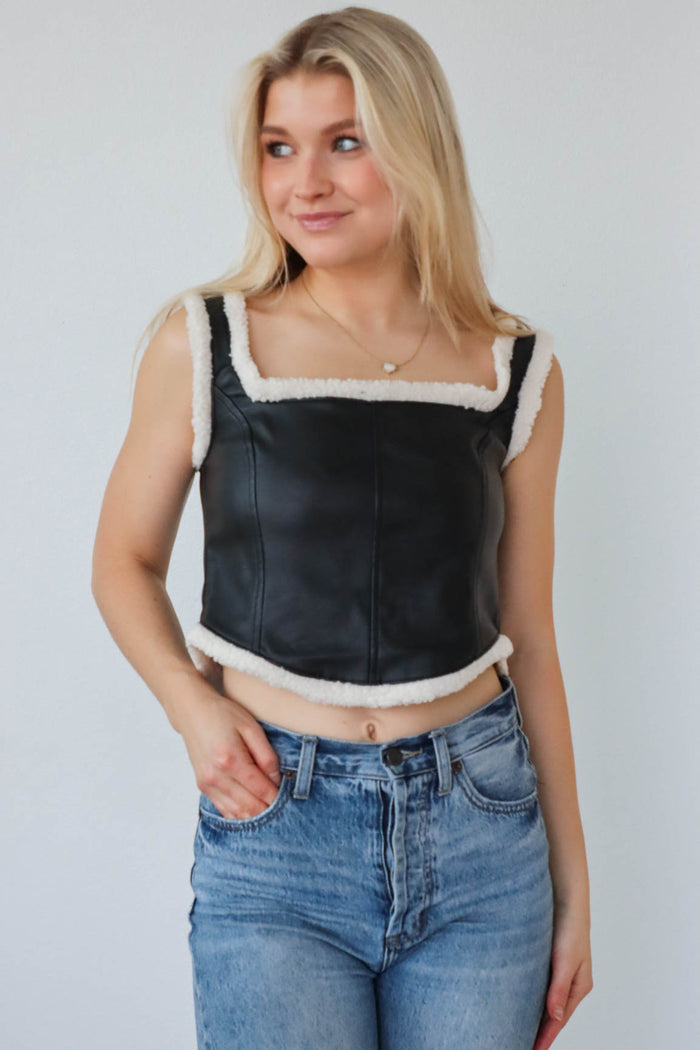 girl wearing faux leather tank top with sherpa detailing