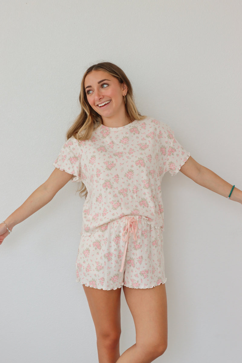 girl wearing light pink floral pj set