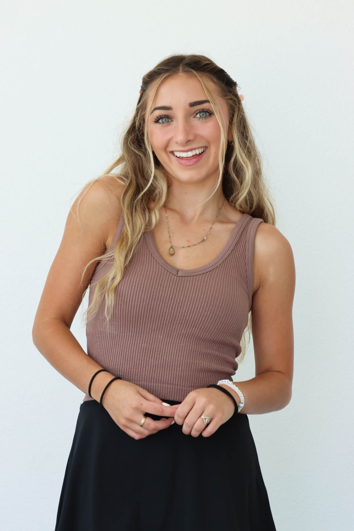 girl wearing light brown ribbed athletic tank