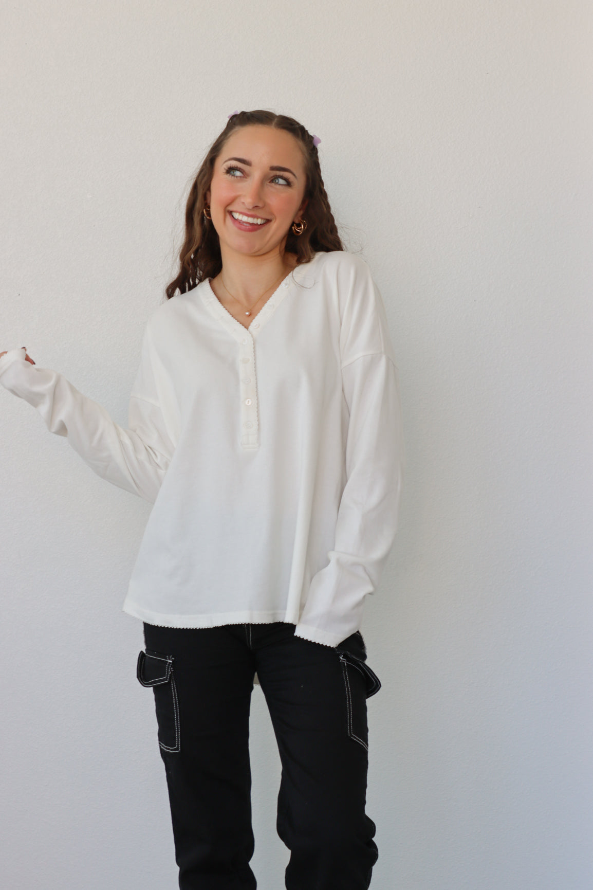 girl wearing white button down long sleeve top