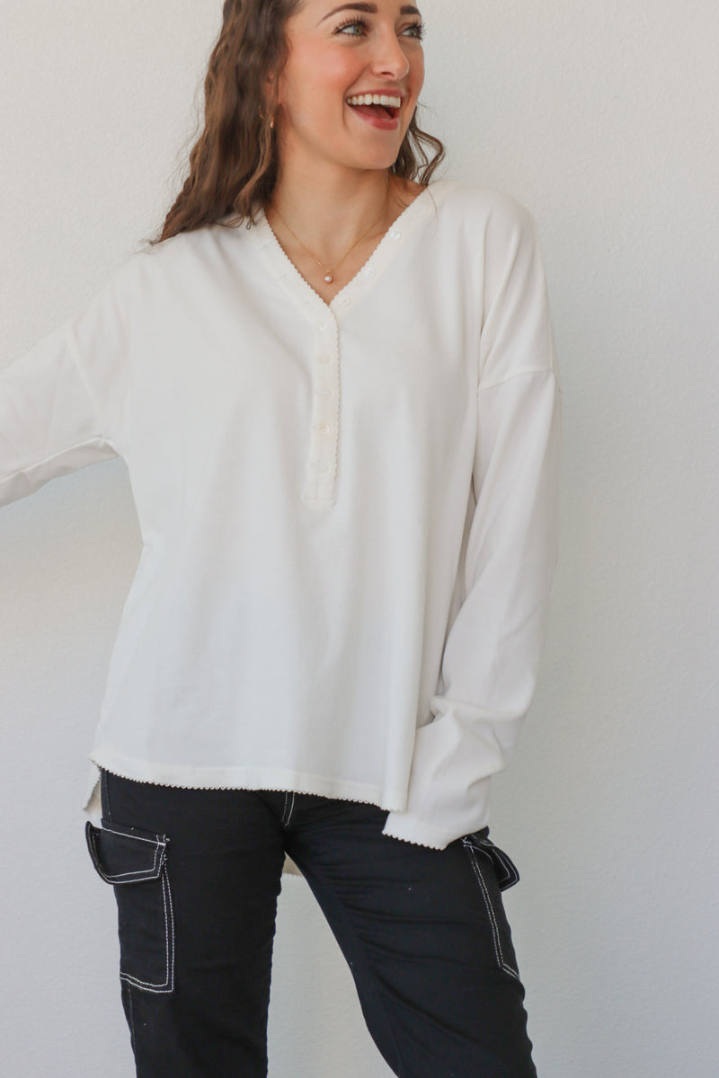 girl wearing white button down long sleeve top