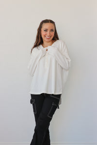 girl wearing white button down long sleeve top