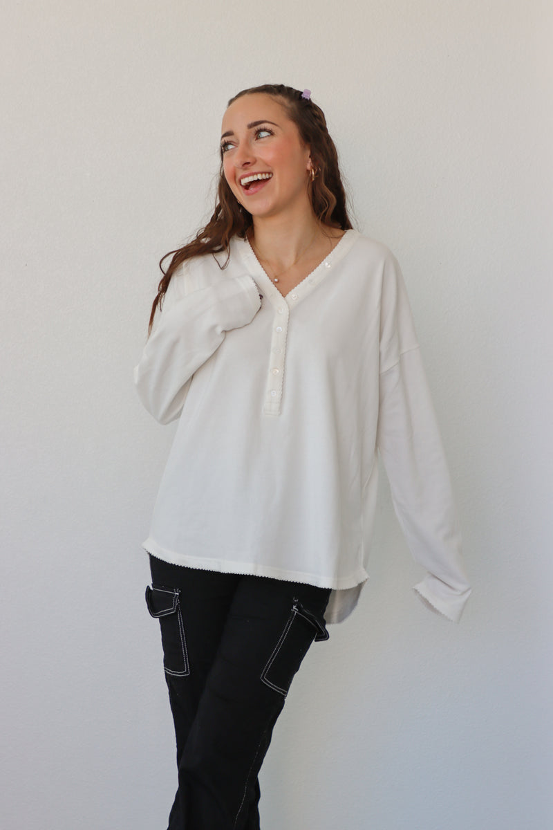 girl wearing white button down long sleeve top