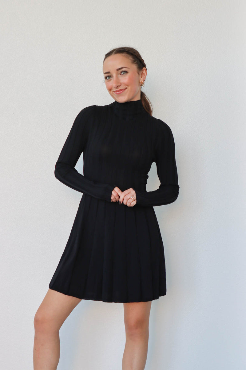 girl wearing short black turtleneck dress