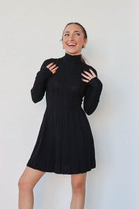 girl wearing short black turtleneck dress