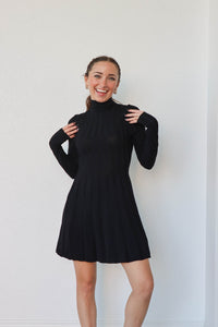 girl wearing short black turtleneck dress