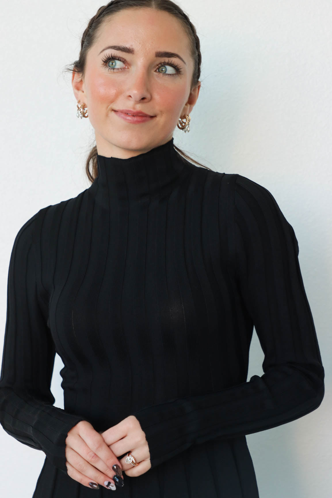 girl wearing short black turtleneck dress