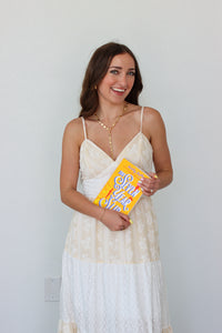 Woman wearing a white tiered maxi dress against a white background 