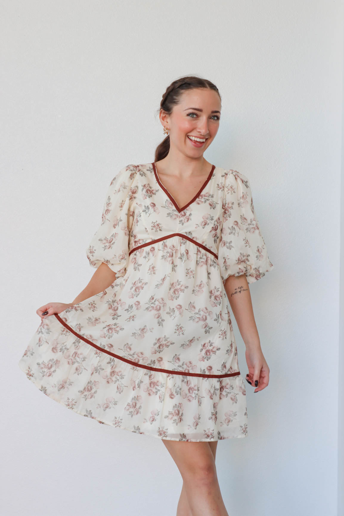 girl wearing cream and red floral dress